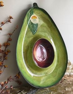 an avocado shaped bowl sitting on top of a table