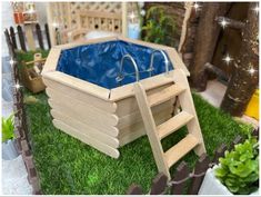 a wooden toy swimming pool in the grass