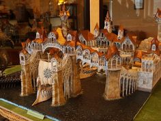 a model of a castle made out of wood and paper machs on display in a store window