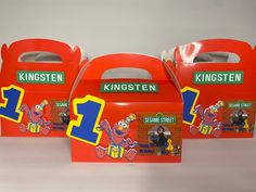 three red boxes with sesame street characters on the front and one blue box with numbers