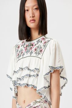 ISABEL MARANT Sana Embroidered Crop Top White embroidered crop top with short sleeves, Crew neck, Zip Closure Composition: 100% Viscose Color: White Fit: True to Size Embroidered Crop Tops, Summer Getaway, Classic Heels, Isabel Marant Etoile, A Perfect Circle, Cynthia Rowley, Luxury Clothing, White Crop Top, Luxury Outfits