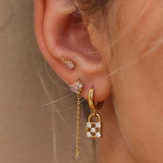 a close up of a person's ear with a lock and chain attached to it