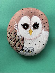 a painted rock with an owl on it