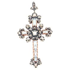 The beauty of tradition and the richness of detail converge in this splendid cross pendant from the 1900s. Crafted in 9-karat yellow gold and 800-millesimal silver, this cross is a tribute to the savoir-faire of yesteryear's goldsmiths. Skillfully set, the rose-cut diamonds shine with a subtle and captivating light, capturing the gaze and reflecting the grandeur of the era from which they come. At the heart of the ornate and complex design stand out Brazilian aquamarines, with a rectangular cut and light color that recalls the crystal-clear waters of tropical shores. The cross, a timeless symbol, here reveals itself in all its splendid elegance, with lines that tell stories of faith and devotion through the centuries. For those who appreciate jewelry with soul and stories to tell, this pen Complex Design, Timeless Symbol, Design Stand, Aqua Marine, Crystal Clear Water, Yellow Gold Pendants, Rose Cut Diamond, Gold Pendant Necklace, Rose Cut