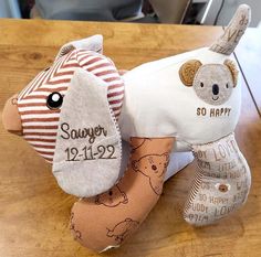 two stuffed animals sitting on top of a wooden table next to each other with the words so happy written on them