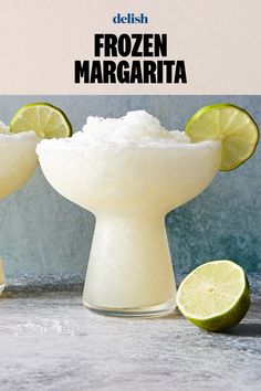 two margaritas are garnished with sugar and lime slices on a table next to each other