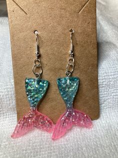 Pink and Blue Sparkle Mermaid Resin Earrings To return to my homepage, click the below: https://www.etsy.com/shop/AllisonsJewels Mermaid Tail Earrings, Mermaid Glitter, Mermaid Earrings, Blue Sparkle, Blue Sparkles, Earrings Pink, Resin Earrings, Mermaid Tail, Glass Heart