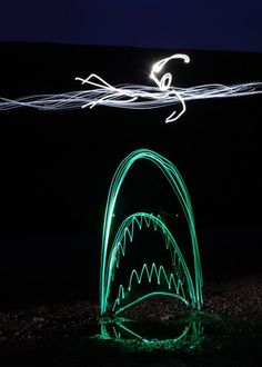 a light painting of a shark with its mouth open