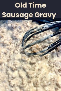 an old time sausage gravy is being stirred with a whisk