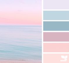 a woman standing on top of a sandy beach next to the ocean in front of a pink and blue sky