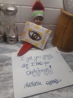 an elf's note is on the counter next to a toothbrush