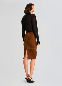 Retrofete's Marcella Suede Skirt is a timeless piece that will elevate any outfit. Crafted from luxurious suede, this skirt features a flattering A-line silhouette that falls just above the knee. The skirt is finished with a delicate zip closure and a stylish side slit. Shown here in Cinnamon. 100% Goat Leather Made in India Model is 5'10" wearing size S Style No. FW24-9718 Bridal Reception Dress, Jumpsuit And Blazer, Bride Bachelorette, Bachelorette Party Bride, Rehearsal Dress, Denim Sweater, Sequin Sweater, Suede Skirt, Reception Dress