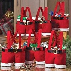 several red bags with santa claus's hats on them