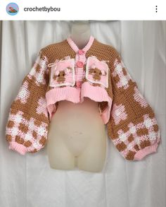 a knitted teddy bear jacket on top of a mannequin head