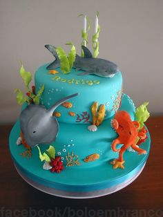 a blue cake decorated with sea animals and fish