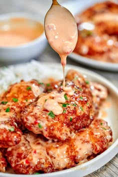 a spoon drizzling sauce over some food