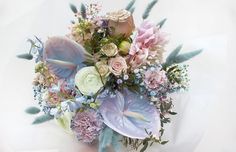 a bouquet of flowers sitting on top of a white table