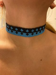 Hand beaded with premium Czech glass seed beads in black and cyan blue with premium Miyuki nylon threads. Pattern is a star like diamond. Lobster claw closure with a stainless steel chain collar. Beaded length is 12 inches with an extension of 2 1/2 inches. Hypoallergenic and nickel free. Bead Loom Choker, Blue Tiny Beads Choker For Festival, Adjustable Turquoise Bead Choker, Turquoise Jewelry With Black Beads For Festival, Blue Beaded Choker For Festival, Blue Spacer Beads For Festivals, Turquoise Beaded Necklaces With Black Beads For Festival, Adjustable Turquoise Beaded Chain Choker, Handmade Blue Choker For Festivals