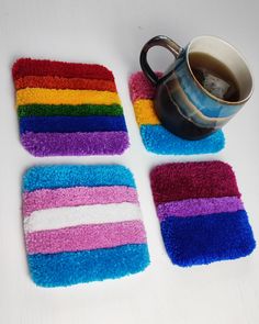 four coasters with different colors on them next to a coffee cup and teapot