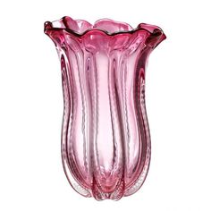 a pink glass vase sitting on top of a white table