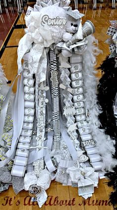 several pieces of white and black ribbons on a wooden floor