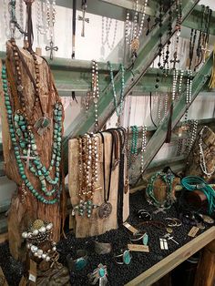 an image of necklaces on display in a store window with the caption'from ploma com ez visit '