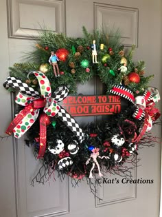 a christmas wreath on the front door with decorations around it and an inscription welcome to the red robin