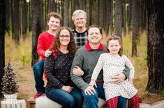 a family posing for a photo in the woods