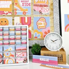 a desk with a clock, calendars and post it notes on the wall behind it