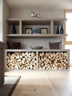 a living room filled with lots of firewood stacked on top of each other next to a couch