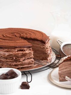 a chocolate cake on a plate with a slice cut out