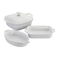 three white dishes with lids and trays