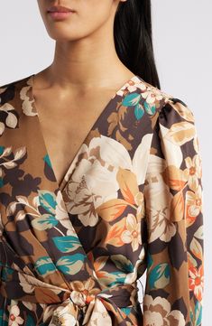 An autumnal floral pattern lends personality to a faux-wrap dress designed with graceful cascading ruffles. 49 1/2" length Hidden back zip with hook-and-eye closure Surplice V-neck Long sleeves Removable tie belt Lined 97% polyester, 3% spandex Dry clean Imported