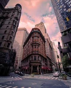 a city street with tall buildings in the background