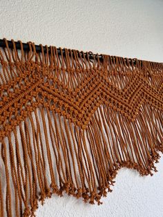 a close up of a wall hanging with fringes