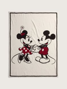 the mickey and minnie towel is on display in front of a white background with red trim