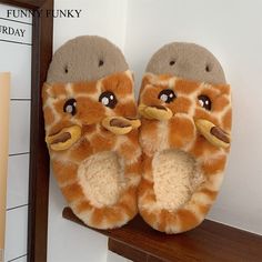 a pair of giraffe slippers are sitting on a shelf