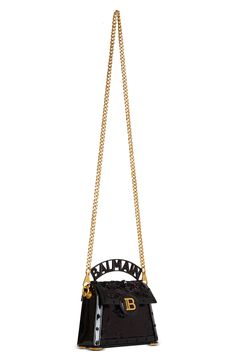 Balmain expands the B-Buzz line with this sequined bag in a structured silhouette traced with tonal disc studs and topped with a banner-style logo handle. A removable crossbody chain strap offers an additional carrying option, while engraved logo hardware puts the label's signature stamp on the look. Magnetic-snap flap closure Top carry handle; removable chain strap Exterior slip pocket Interior wall pocket Structured silhouette with flat base and protective metal feet Lambskin-leather lining Te Signature Stamp, Small B, Engraved Logo, Interior Wall, Wall Pockets, Handle Bag, Lambskin Leather, Leather Top, Chain Strap