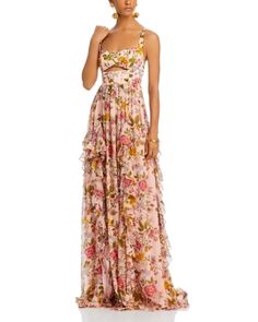 a woman in a long dress with flowers on it