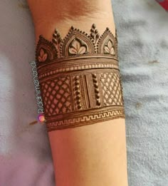 hendi tattoos on the arm and wrist are very attractive for women to see in this photo