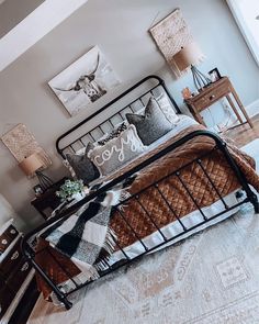 a bed room with a neatly made bed and pictures on the wall