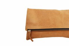 Elevate your handbag collection with this soft to the touch, genuine leather camel color fold over clutch bag. A good handbag is hard to find! Simple design with high-quality leather will leave you impressed. Great for day or night! Shop now. (PRODUCT INFO): Size: 11.5" x 11.5" inches Material: Genuine cow leather Lining: Suede Brass YKK zipper (SHIPPING INFO): All our items are made-to-order, therefore please allow 3-5 business days for production. Our goal is to become more sustainable through Best Leather Wallet, Brown Leather Clutch, Clare Vivier, Best Handbags, Leather Clutch Bags, Genuine Leather Handbag, Leather Pouch, Leather Satchel, Fold Over