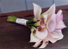 a bouquet of flowers sitting on top of a wooden table