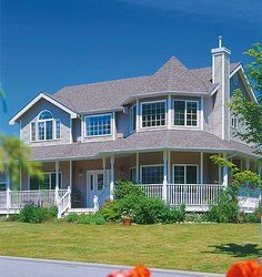 a large white house sitting on top of a lush green field