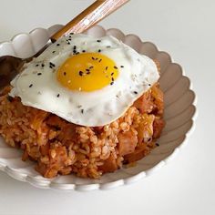 an egg on top of rice in a bowl