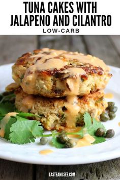 two crab cakes with jalapeno and cilantro on a white plate