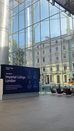 a large building with lots of windows on the outside and in front of it is a sign that says imperial college london