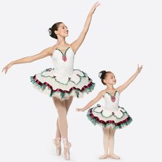 two young ballerinas dressed in white and green tutus, one holding her arms out