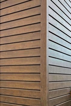 a bench sitting next to a tall wooden building