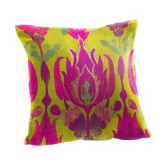 a yellow and pink pillow with flowers on the front, sitting against a white background